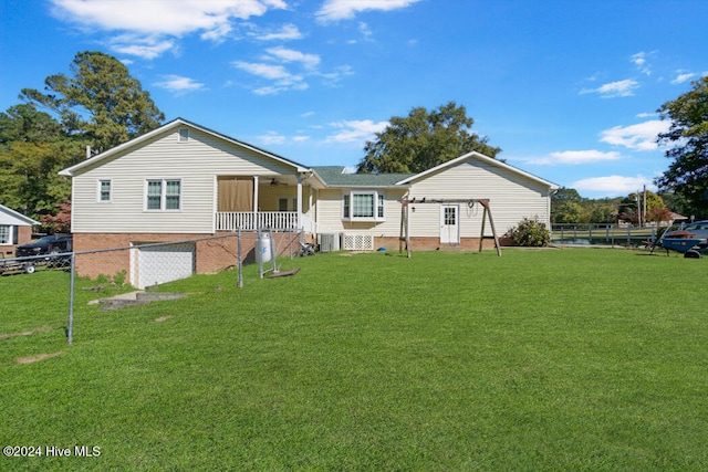 back of property featuring a lawn