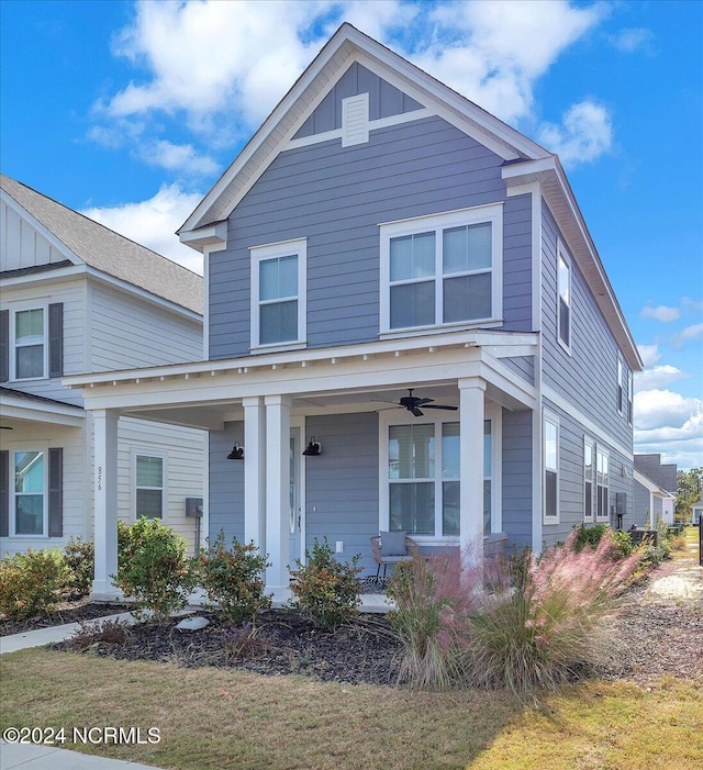 view of front of home featuring a front yard, a porch, and ceiling fan