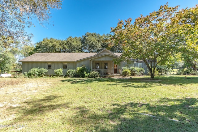 ranch-style house with a front lawn and covered porch