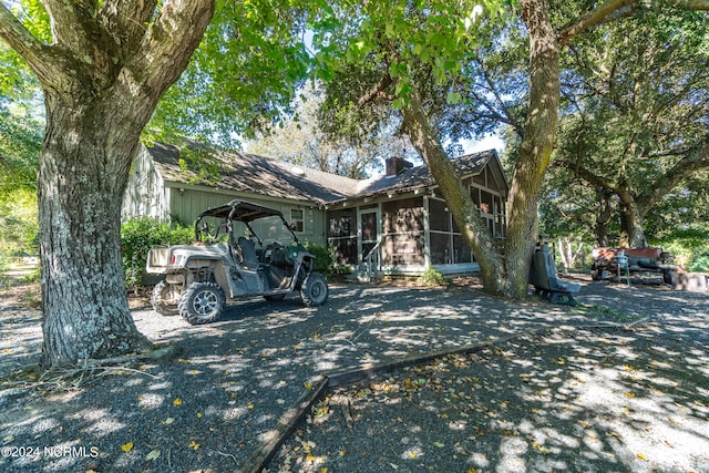 view of front of house featuring a sunroom and a carport