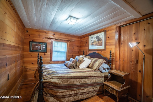 bedroom with wood walls, wooden ceiling, and wood-type flooring