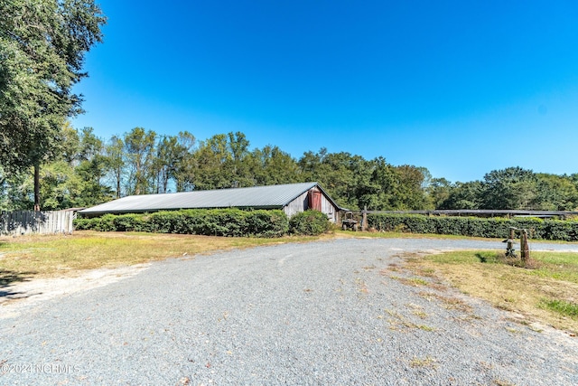 view of road with an outbuilding and gravel driveway