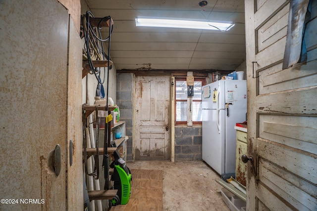 basement featuring white fridge