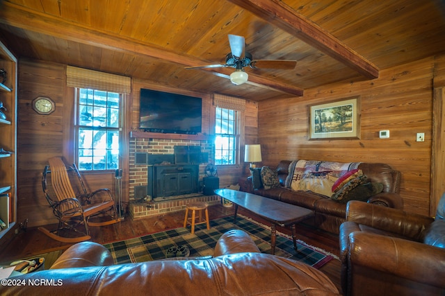 living room with wood walls, wood ceiling, ceiling fan, beam ceiling, and hardwood / wood-style flooring