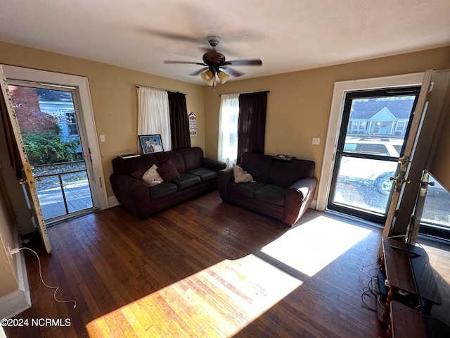 living room featuring wood-type flooring and ceiling fan