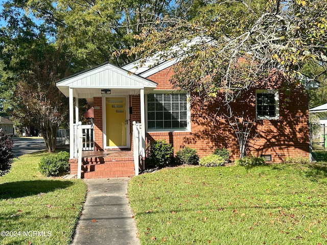 bungalow-style home with a front lawn