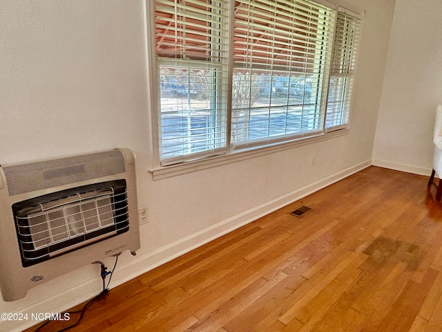 interior space featuring heating unit and hardwood / wood-style floors