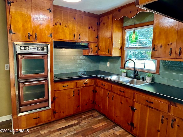 kitchen with tasteful backsplash, black appliances, sink, and dark hardwood / wood-style flooring