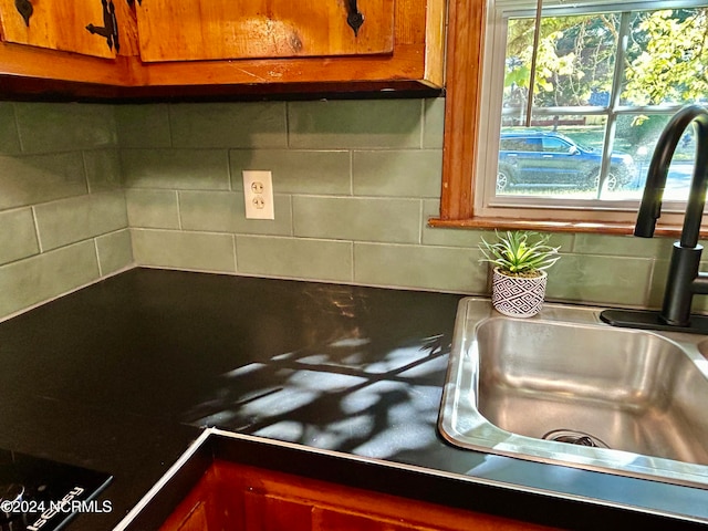 interior space with decorative backsplash and sink