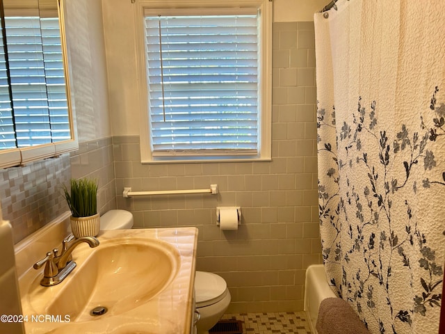 full bathroom with toilet, tile patterned flooring, vanity, tile walls, and shower / bathtub combination with curtain