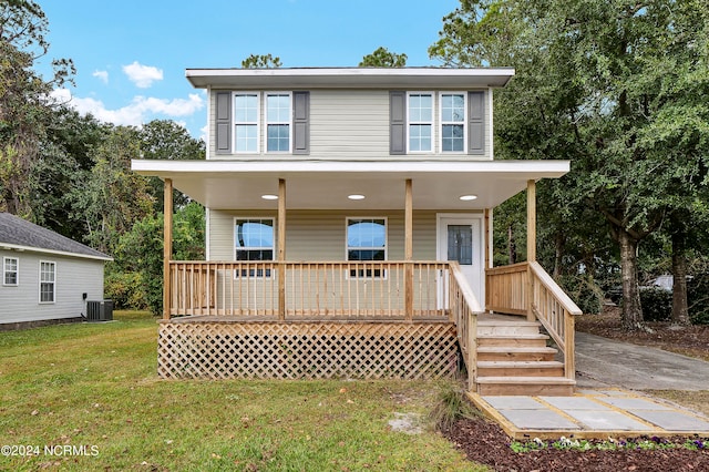 view of front of home featuring a front lawn and central AC unit