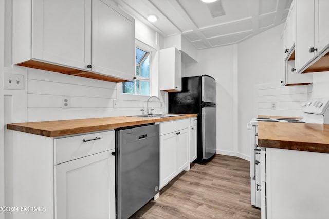 kitchen featuring appliances with stainless steel finishes, wood counters, white cabinets, and light hardwood / wood-style floors