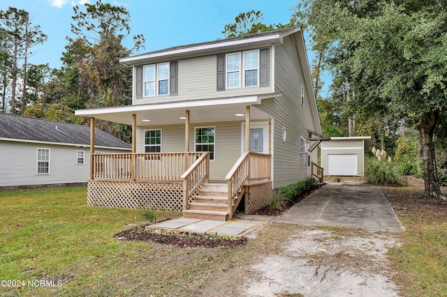 view of front of house with a front yard, an outdoor structure, a garage, and a deck