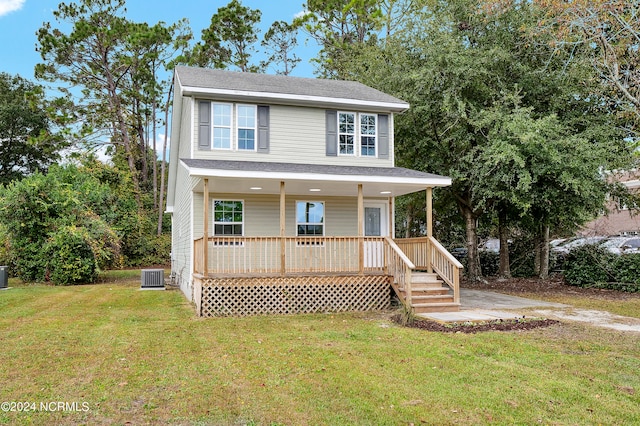 view of front of house featuring a front lawn and central air condition unit