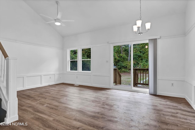 unfurnished living room with high vaulted ceiling, ceiling fan with notable chandelier, and dark hardwood / wood-style flooring