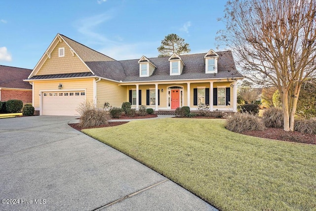 cape cod house with covered porch, a garage, and a front yard