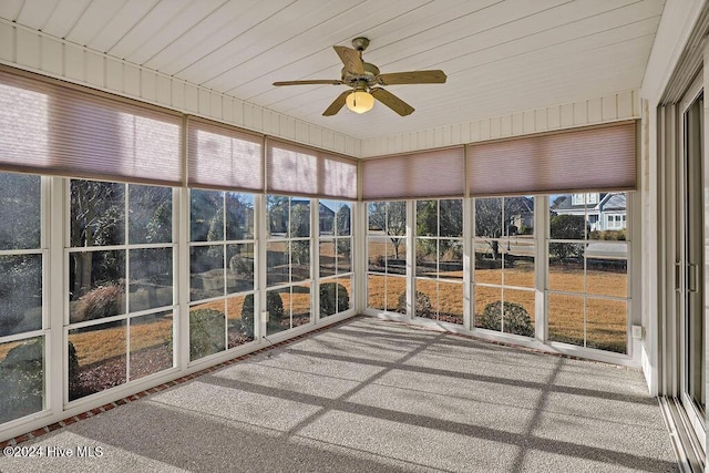 unfurnished sunroom with ceiling fan and a healthy amount of sunlight