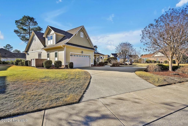 view of front of home with a garage and a front yard