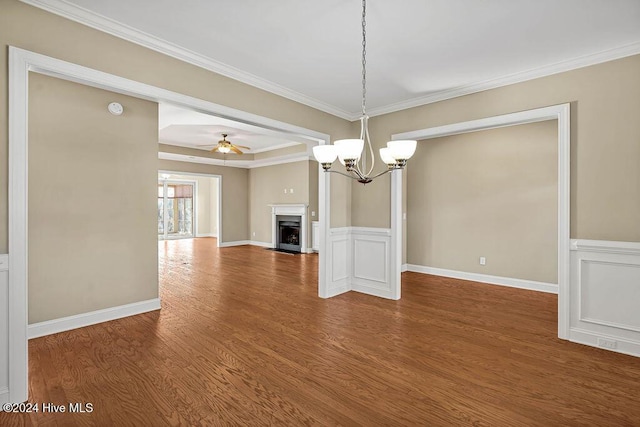 interior space featuring hardwood / wood-style flooring, ceiling fan with notable chandelier, and crown molding