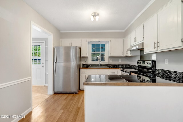 kitchen featuring light hardwood / wood-style flooring, sink, crown molding, white cabinetry, and appliances with stainless steel finishes