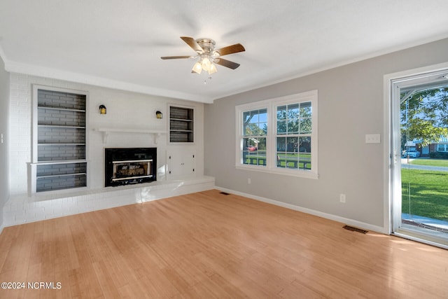 unfurnished living room with light hardwood / wood-style floors, crown molding, and ceiling fan