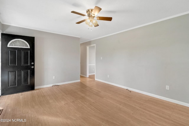 spare room featuring ceiling fan, crown molding, and light hardwood / wood-style flooring