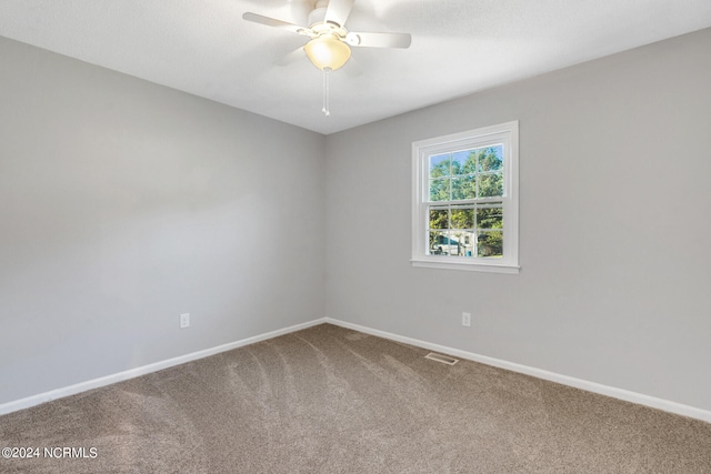 carpeted spare room with ceiling fan