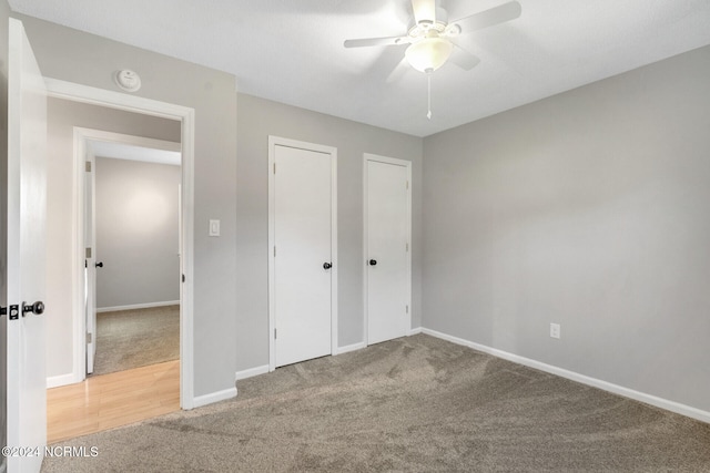 unfurnished bedroom with ceiling fan and carpet