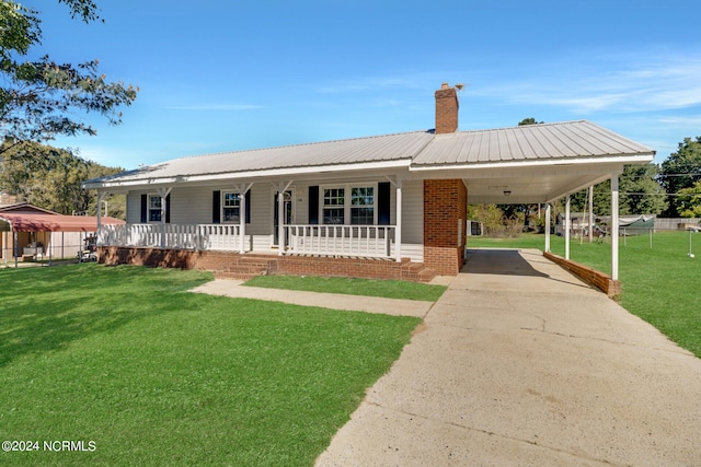 view of front of house with a carport, a front yard, and a porch