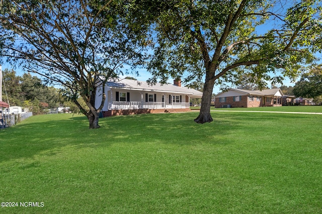 view of front facade with a front lawn and a porch