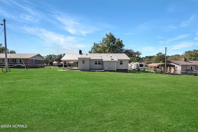 rear view of house with a lawn