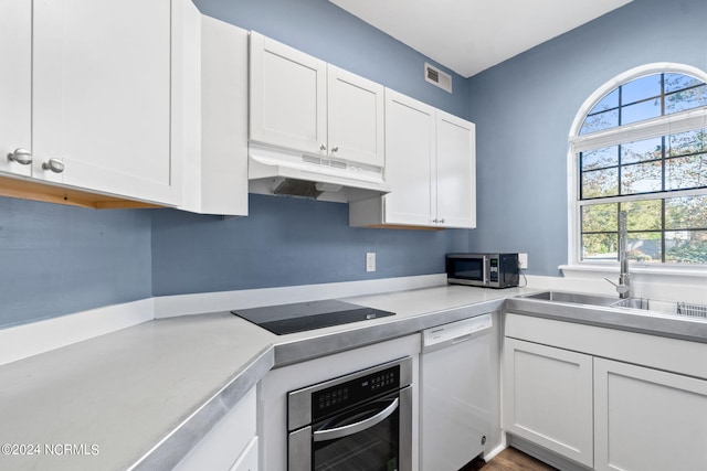 kitchen featuring white cabinetry, a healthy amount of sunlight, and appliances with stainless steel finishes