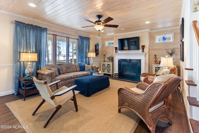 living room with ornamental molding, wood ceiling, wood-type flooring, and ceiling fan