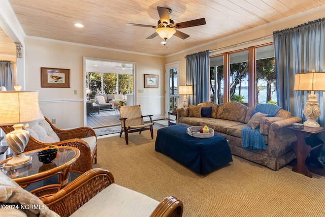 living room featuring wood ceiling, crown molding, carpet, and ceiling fan