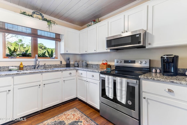 kitchen featuring light stone countertops, sink, white cabinetry, stainless steel appliances, and crown molding