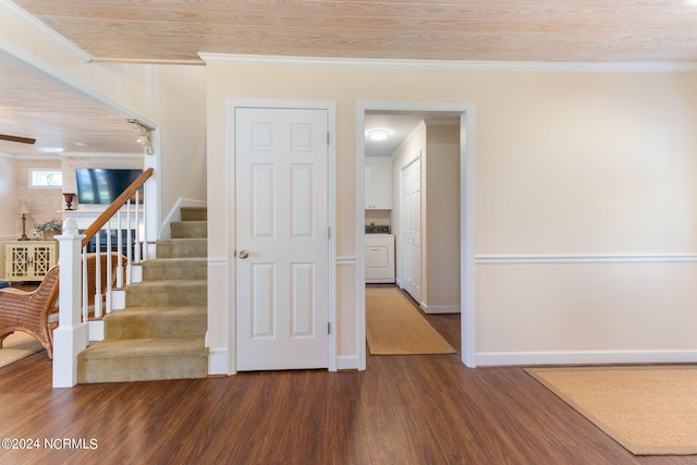 staircase with crown molding, wood-type flooring, and washer / clothes dryer