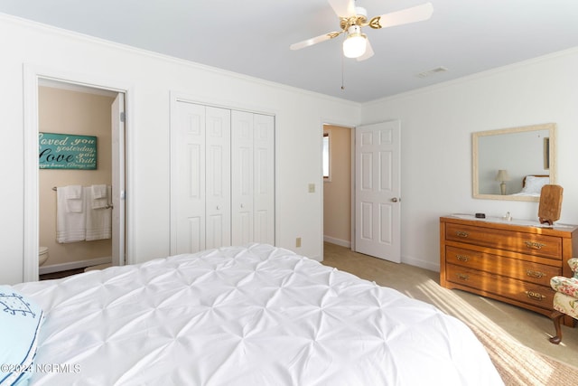 carpeted bedroom featuring a closet, ornamental molding, and ceiling fan