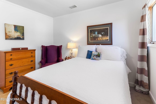 carpeted bedroom featuring crown molding