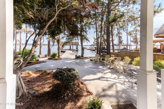 view of home's community with a patio and a water view