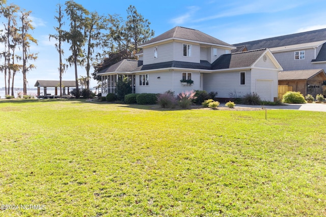 exterior space featuring a garage and a lawn