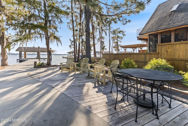 wooden terrace featuring a water view