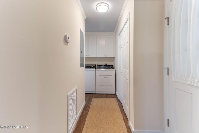 hallway featuring light hardwood / wood-style floors, crown molding, and washer and clothes dryer