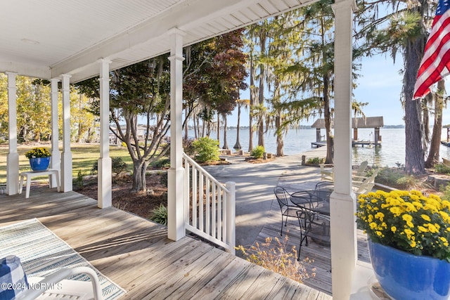 wooden terrace with a dock and a water view