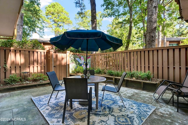 view of patio with outdoor dining area and a fenced backyard