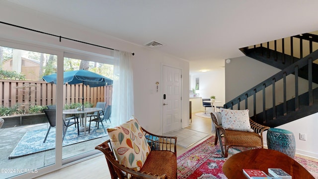 living area featuring visible vents and stairway