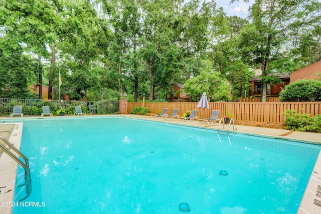 community pool featuring a fenced backyard