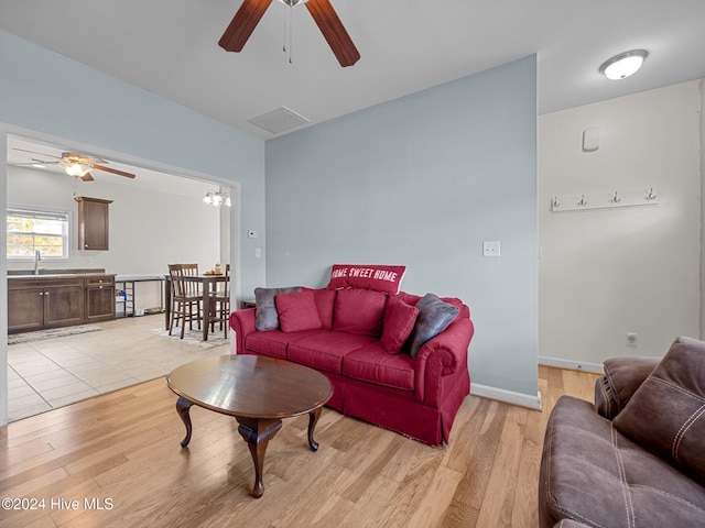 living room with light hardwood / wood-style flooring and sink