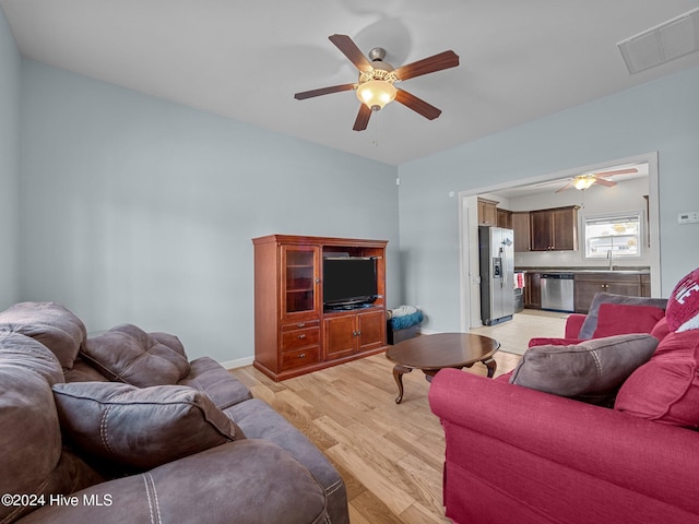 living room with ceiling fan and light hardwood / wood-style floors