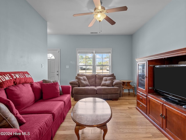 living room with light hardwood / wood-style flooring and ceiling fan