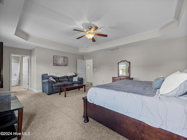 carpeted bedroom with ceiling fan, a raised ceiling, and ornamental molding